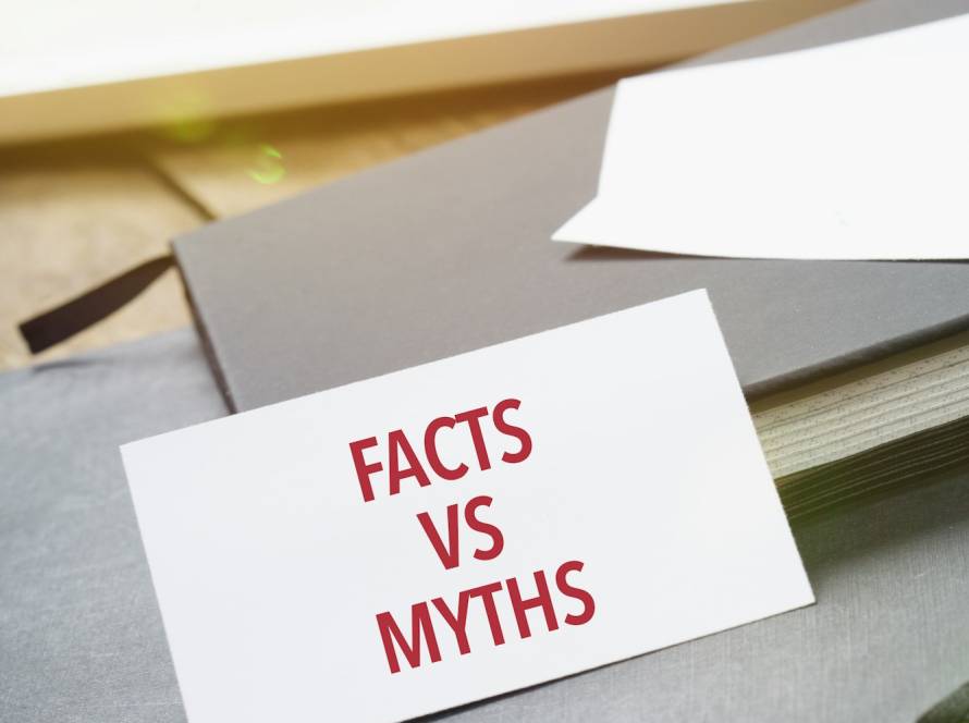 Facts vs Myths on card at office desktop