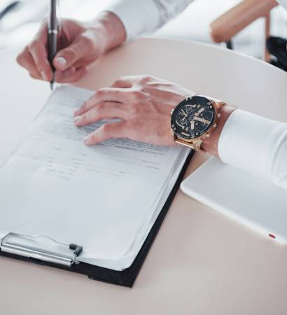 Young man signs documents in the office, successful sales